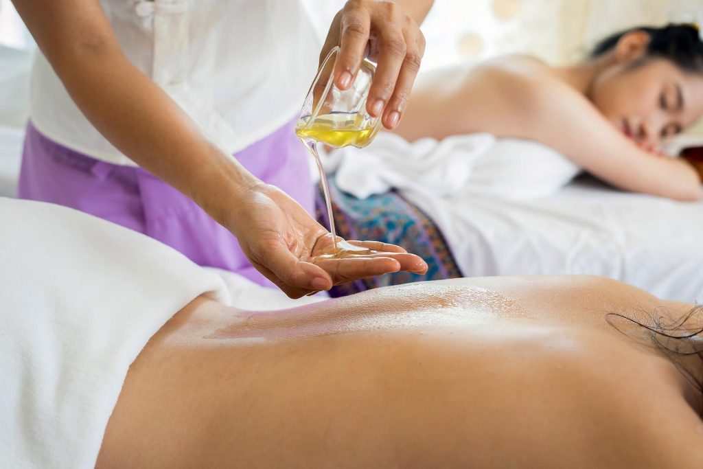 woman lying with prone position getting a massage with oil