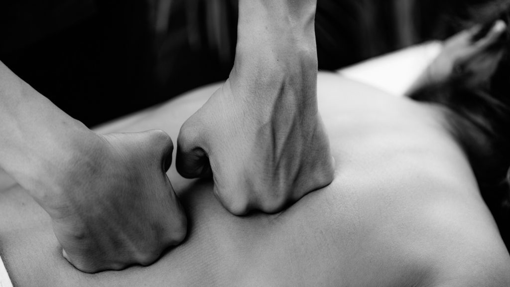 Back Massage in spa. Deep Tissue Massage of Woman’s Back