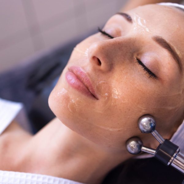 Woman getting microcurrent facial