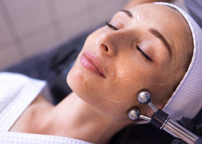 Woman getting microcurrent facial