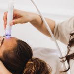 Beauty Therapist Performing Hydrafacial Procedure On Woman