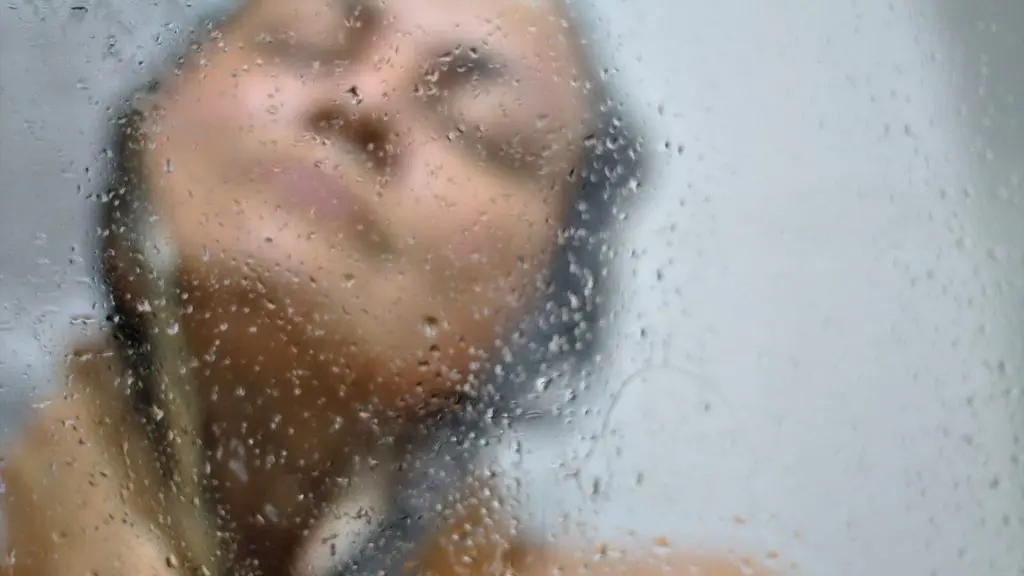 Woman in bath with wet water glass
